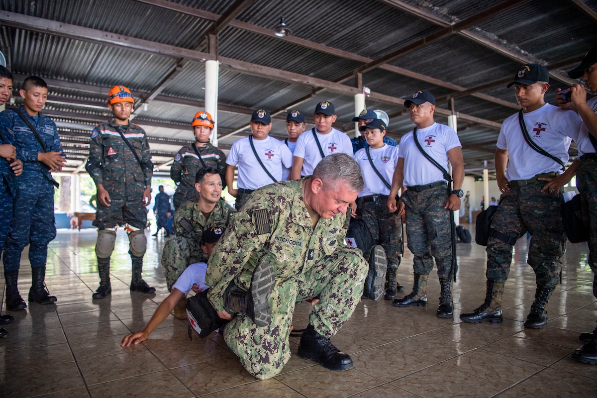 Chief Hospital Corpsman Joey Bradley, center left, from Dixon, California, and Cmdr. Stuart Hitchcock, from Asheville, North Carolina, both attached to the Military Sealift Command hospital ship USNS Comfort (T-AH 20), teach tactical combat casualty care to Guatemalan service members during a subject matter expert exchange in Puerto Barrios, Guatemala, Oct. 26, 2022.