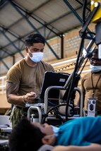 221027-N-LP924-1075 PUERTO BARRIOS, Guatemala (Oct. 27, 2022) Hospital Corpsman 2nd Class Emmanuel Quindoy, a native of San Diego, attached to the hospital ship USNS Comfort (T-AH 20), takes x-rays of a local patient at a medical site in Puerto Barrios, Guatemala, Oct. 27, 2022. Comfort is deployed to U.S. 4th Fleet in support of Continuing Promise 2022, a humanitarian assistance and goodwill mission conducting direct medical care, expeditionary veterinary care, and subject matter expert exchanges with five partner nations in the Caribbean, Central and South America. (U.S. Navy photo by Mass Communication Specialist 3rd Class Sophia Simons)