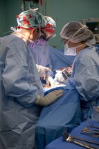 221027-N-DF135-1186 PUERTO BARRIOS, Guatemala (Oct. 27, 2022) – Lt. Cmdr. Andrew Friski, from Lexington, Virginia, left, Lt. Kristen Heye, from Amarillo, Texas, center, and. U.S. Air Force Capt. Sarah Price Faulkner, from Tuscaloosa, Alabama, perform a hysterectomy aboard the hospital ship USNS Comfort (T-AH 20), Oct. 27, 2022. Comfort is deployed to U.S. 4th Fleet in support of Continuing Promise 2022, a humanitarian assistance and goodwill mission conducting direct medical care, expeditionary veterinary care, and subject matter expert exchanges with five partner nations in the Caribbean, Central and South America. (U.S. Navy photo by Mass Communication Specialist Seaman Deven Fernandez)