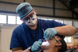 221027-N-LP924-1047 PUERTO BARRIOS, Guatemala (Oct. 27, 2022) Lt. Kevin Cambell, a native of Taunton, Massachusetts, attached to the hospital ship USNS Comfort (T-AH 20), performs an oral exam on a local patient at a medical site in Puerto Barrios, Guatemala, Oct. 27, 2022.  Comfort is deployed to U.S. 4th Fleet in support of Continuing Promise 2022, a humanitarian assistance and goodwill mission conducting direct medical care, expeditionary veterinary care, and subject matter expert exchanges with five partner nations in the Caribbean, Central and South America. (U.S. Navy photo by Mass Communication Specialist 3rd Class Sophia Simons)