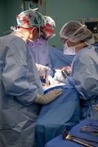 221027-N-DF135-1186 PUERTO BARRIOS, Guatemala (Oct. 27, 2022) – Lt. Cmdr. Andrew Friski, from Lexington, Virginia, left, Lt. Kristen Heye, from Amarillo, Texas, center, and. U.S. Air Force Capt. Sarah Price Faulkner, from Tuscaloosa, Alabama, perform a hysterectomy aboard the hospital ship USNS Comfort (T-AH 20), Oct. 27, 2022. Comfort is deployed to U.S. 4th Fleet in support of Continuing Promise 2022, a humanitarian assistance and goodwill mission conducting direct medical care, expeditionary veterinary care, and subject matter expert exchanges with five partner nations in the Caribbean, Central and South America. (U.S. Navy photo by Mass Communication Specialist Seaman Deven Fernandez)