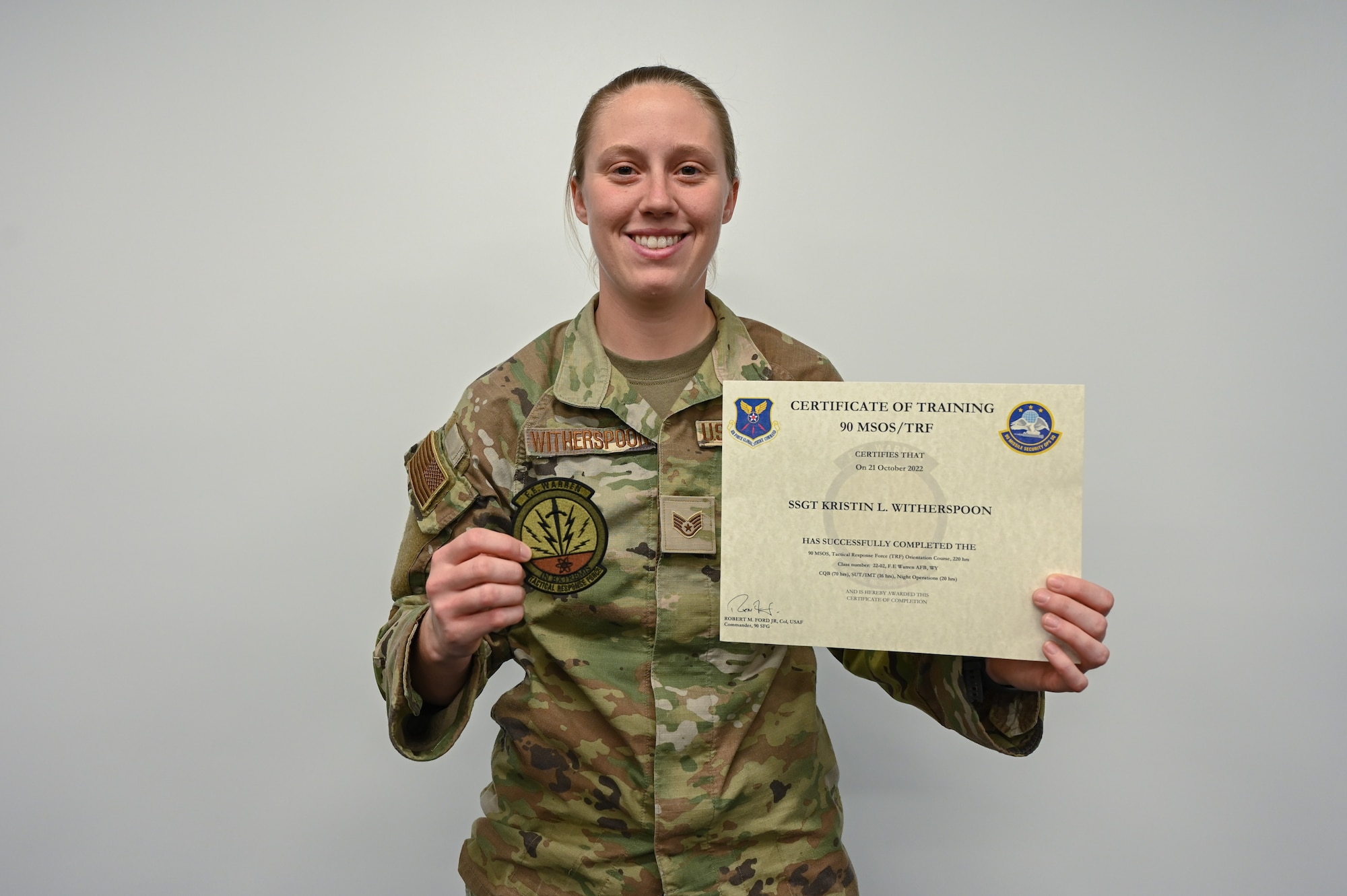 Staff Sgt. Witherspoon poses with her TRF certificate
