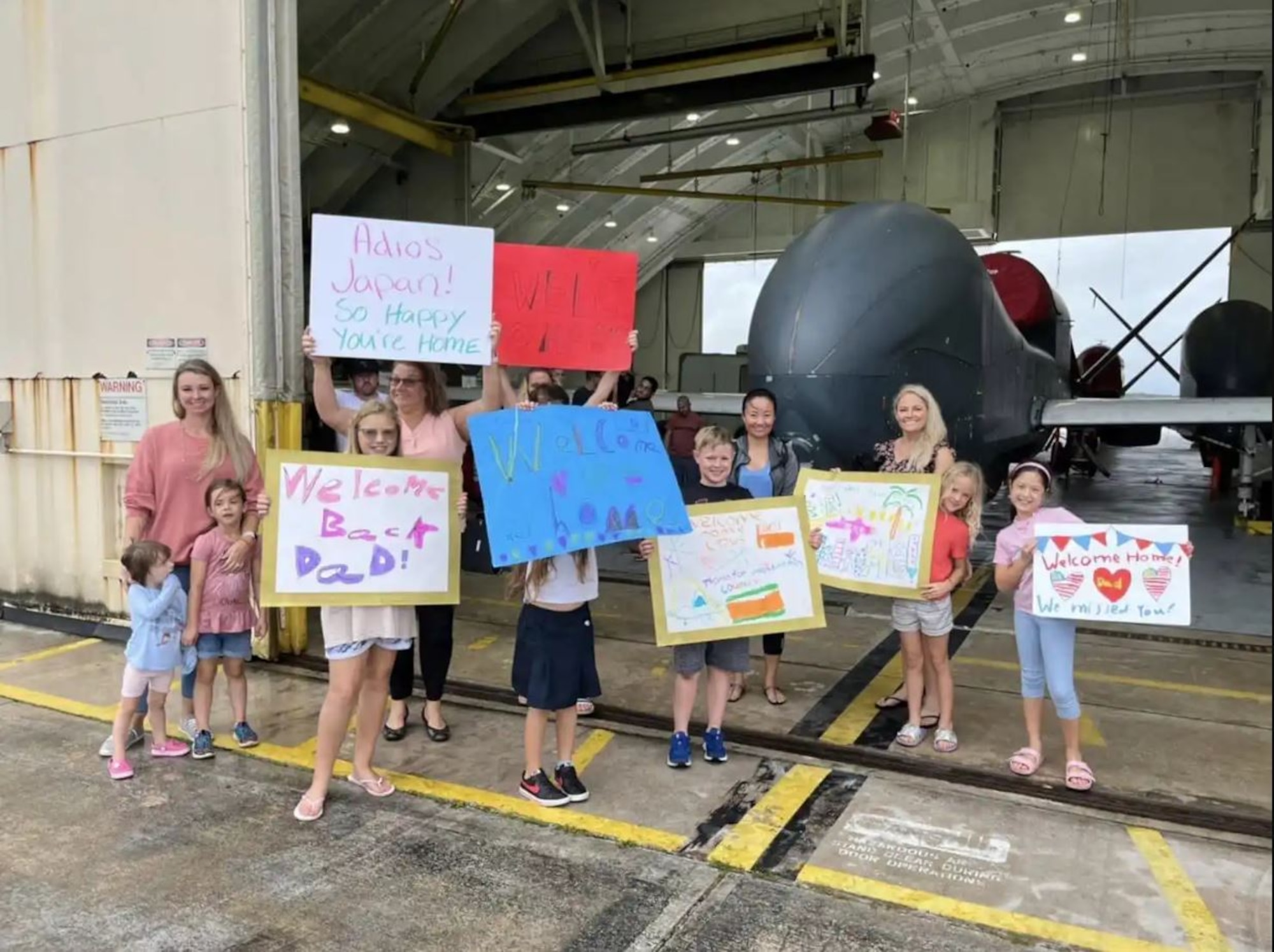 Family members and friends greet members of the 4th Reconnaissance Squadron returning from deployment at Andersen Air Force Base, Guam. The 4 RS has deployed to Japan nearly every year since 2014 and this year they deployed 80 personnel from May to October. (Courtesy photo)