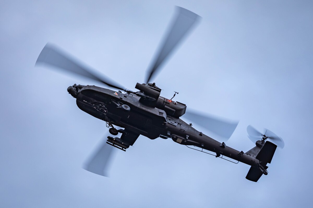 A helicopter hovers above the ground.