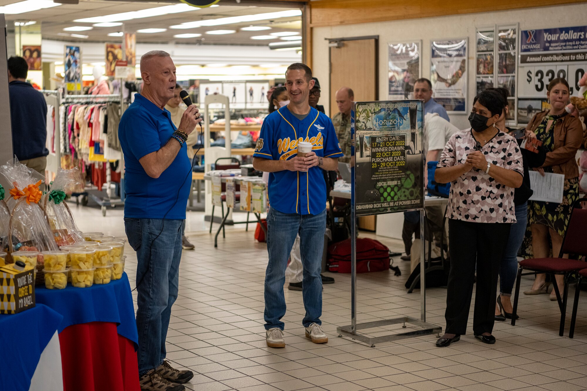 Two people addressing a crowd of over 30 people.