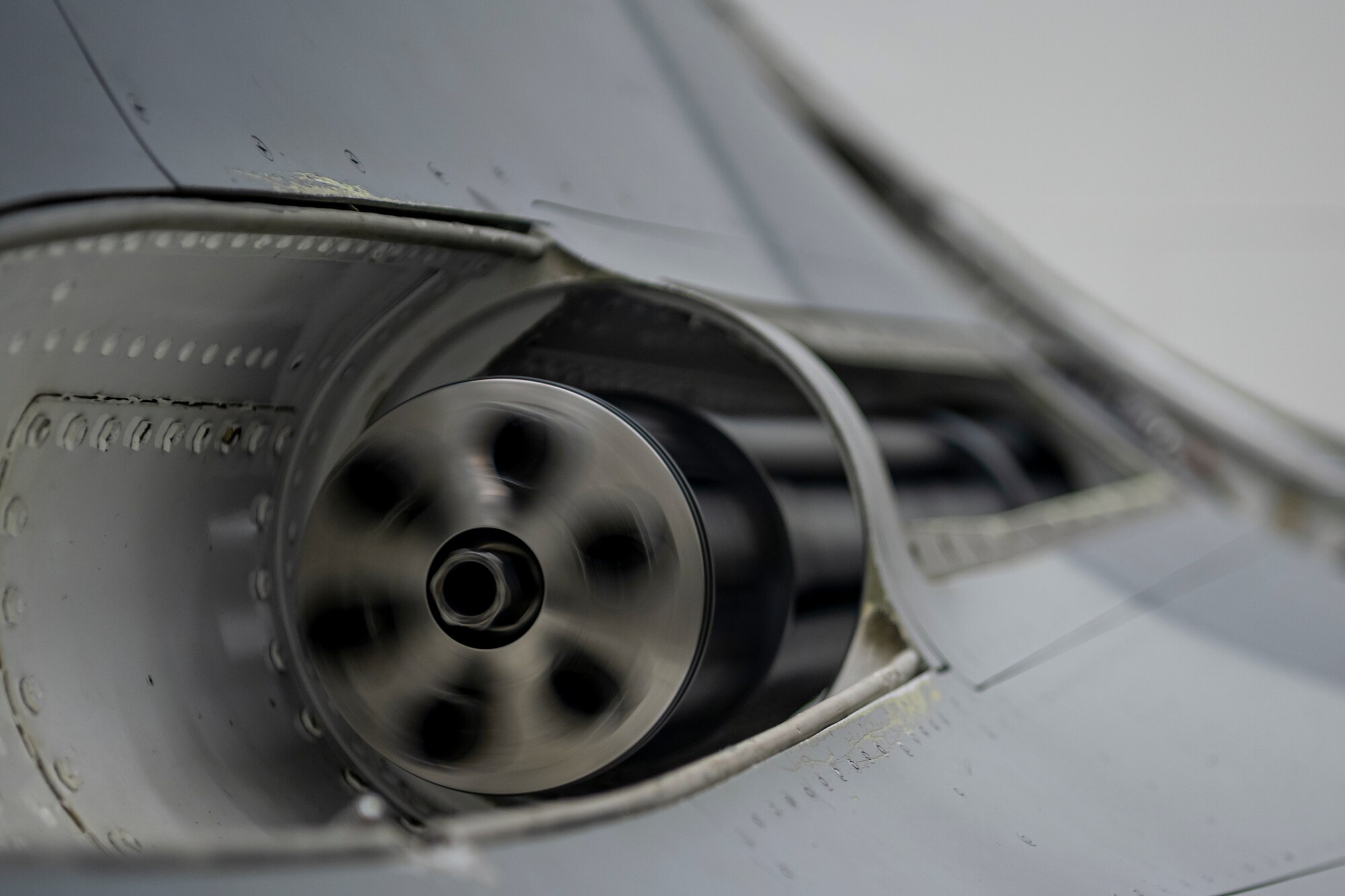 Gun on fighter jet rotating.