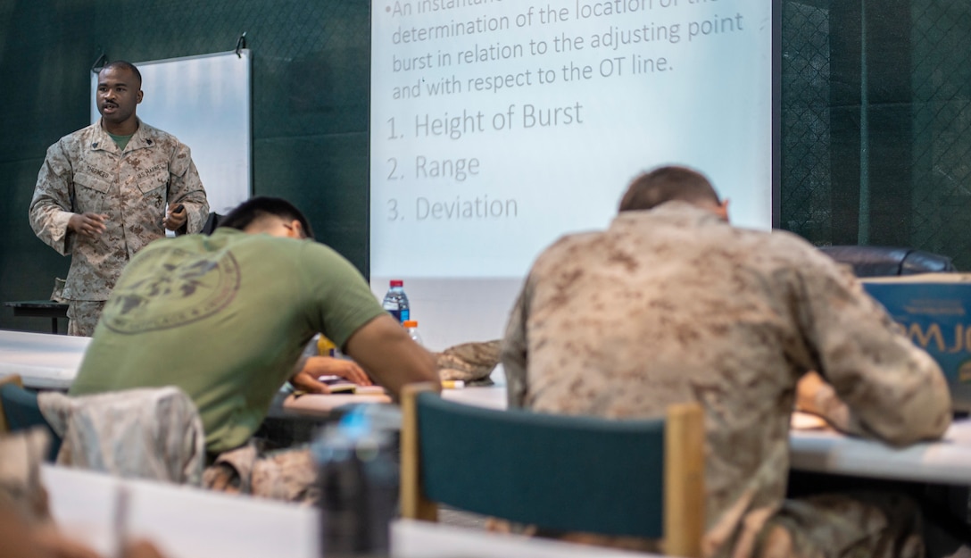 A Marine assigned to Naval Amphibious Task Force 51/5th Expeditionary Brigade (TF 51/5) gives a call for fires class to Marines assigned to Fleet Anti-Terrorism Security Team Central Command (FASTCENT) aboard Naval Support Activity , Bahrain October 12. During the class, the Marines covered grid and polar missions, target identification, target location and radio etiquette