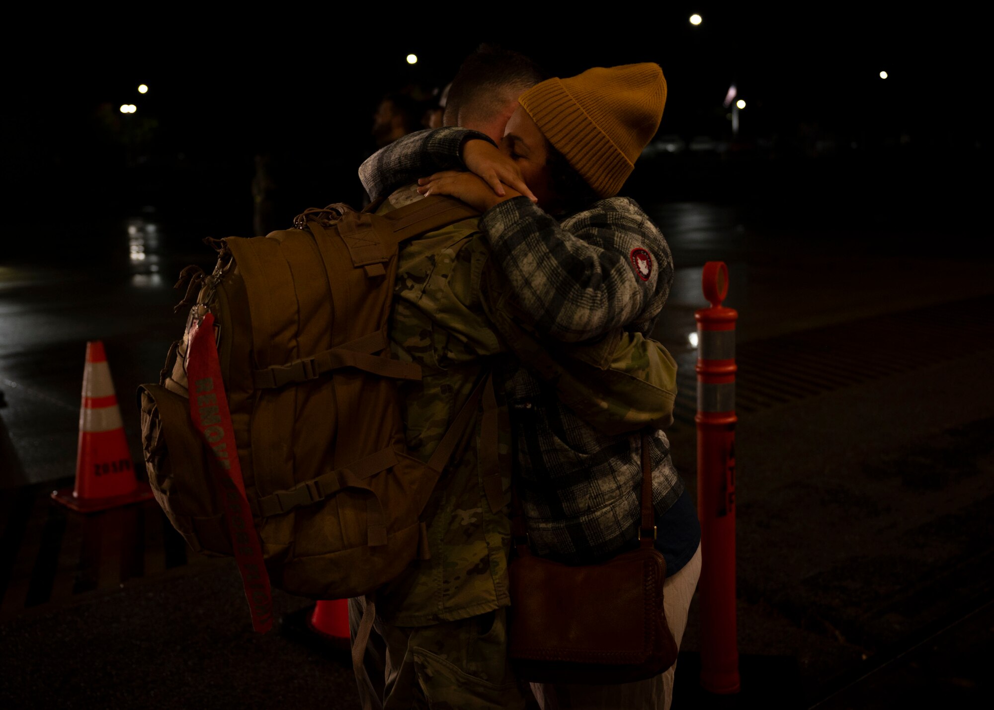 Airman and significant other hug on flightline
