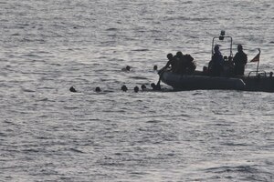 GULF OF OMAN (Oct. 29, 2022) Sailors assigned to patrol coastal ship USS Sirocco (PC 6) rescue mariners from the water in the Gulf of Oman, Oct. 29. The mariners jumped into the water after setting their vessel on fire as U.S. forces approached.