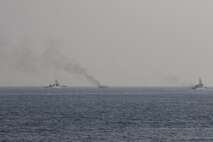 GULF OF OMAN (Oct. 29, 2022) Patrol coastal ships USS Thunderbolt (PC 12) and USS Chinook (PC 9) approach a burning fishing vessel in the Gulf of Oman, Oct. 29. The vessel, found to be smuggling illicit cargo, was set on fire by the fishing vessel’s crew as U.S. forces approached.