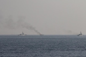 GULF OF OMAN (Oct. 29, 2022) Patrol coastal ships USS Thunderbolt (PC 12) and USS Chinook (PC 9) approach a burning fishing vessel in the Gulf of Oman, Oct. 29. The vessel, found to be smuggling illicit cargo, was set on fire by the fishing vessel’s crew as U.S. forces approached.
