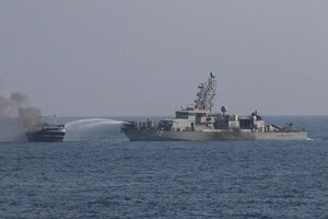 GULF OF OMAN (Oct. 29, 2022) Sailors aboard patrol coastal ship USS Thunderbolt (PC 12) work to extinguish a fire aboard a fishing vessel in the Gulf of Oman, Oct. 29. The vessel, found to be smuggling illicit cargo, was set on fire by the fishing vessel’s crew as U.S. forces approached.