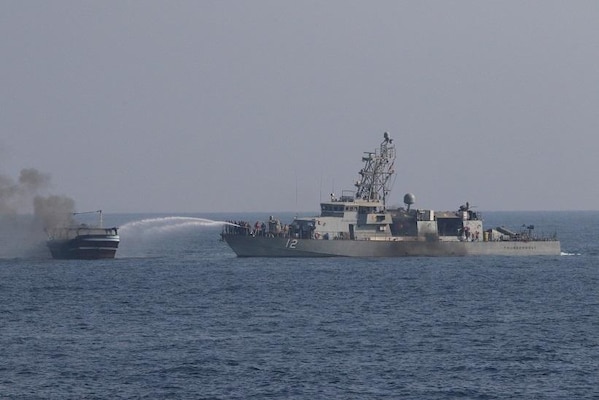 USS Thunderbolt (PC 12) extinguishes a fire aboard a fishing vessel in the Gulf of Oman.