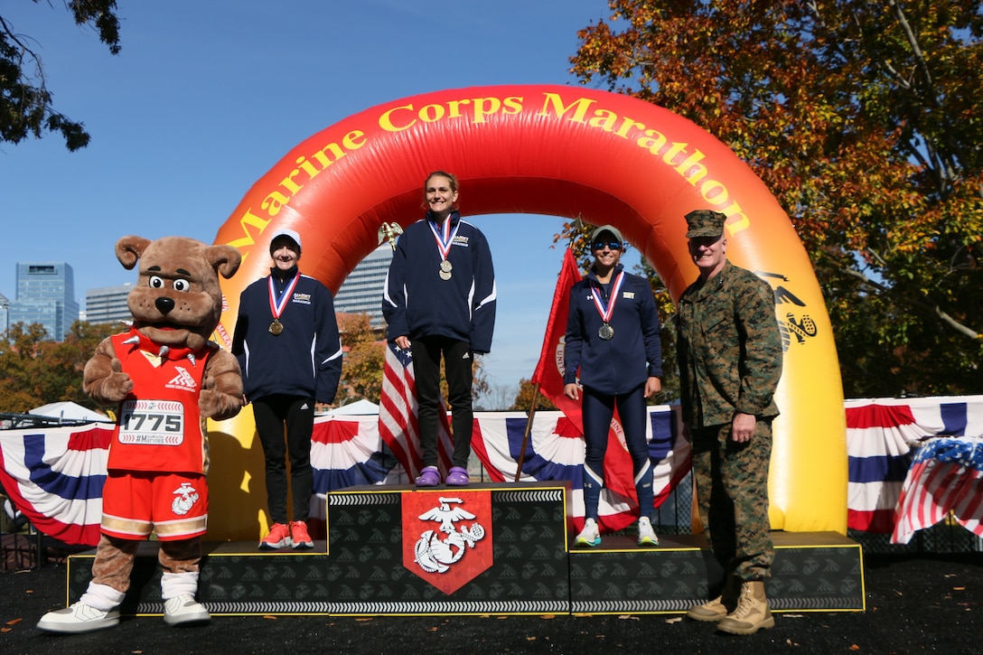 Navy women sweep the podium during the 2022 Armed Forces Marathon Championship held in conjunction with the 47th Marine Corps Marathon in Washington, D.C.  Lt. Cmdr. Katherine Irgens, Coast Guard Fireman Adair Gennorcro, and Lt. Rachel Vigor win gold, silver, and bronze respectively. The Armed Forces Championship features teams from the Marine Corps, Navy (with Coast Guard runners), and Air Force.  Department of Defense Photo by Mr. Steven Dinote - Released.