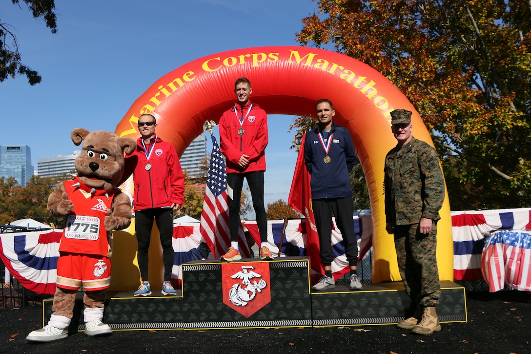 Marine Capt Kyle King, Marine Major Sean Barrett, and Navy Lt. Cmdr. Thomas Betterbed win gold, silver, and bronze respectively during the 2022 Armed Forces Marathon Championship held in conjunction with the 47th Marine Corps Marathon in Washington, D.C.  The Armed Forces Championship features teams from the Marine Corps, Navy (with Coast Guard runners), and Air Force.  Department of Defense Photo by Mr. Steven Dinote - Released.