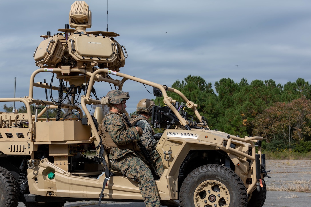 U.S. Marine Corps Pfc. Clayton Hilemon (left) and Sgt. Alexander Locconielsen (right), a low-altitude air-defense gunners with 2nd Low Altitude Air Defense Battalion (LAAD), transmits an electronic signal to an incoming drone with the Light Marine Air Defense Integrated System, or L-MADIS, at Marine Corps Outlying Landing Field Atlantic, North Carolina, Oct. 18, 2022. The L-MADIS is an electronic-attack system that counters unmanned-aircraft system by nonkinetic capabilities to destroy or negate aerial threats. 2nd LAAD is a subordinate unit of 2nd Marine Aircraft Wing, the aviation combat element of II Marine Expeditionary Force. (U.S. Marine Corps photo by Sgt. Servante R. Coba)