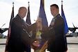 Brig. Gen. Michael Regan, Pennsylvania Air National Guard commander (left) and Col. Edward Fink Jr., 193rd Special Operations Wing commander (right) exchange the guidon at an assumption of command ceremony Oct. 28, 2022, Middletown, Pennsylvania. The ceremonial passing of the guidon to Fink marks the beginning of his command of the 193rd SOW.