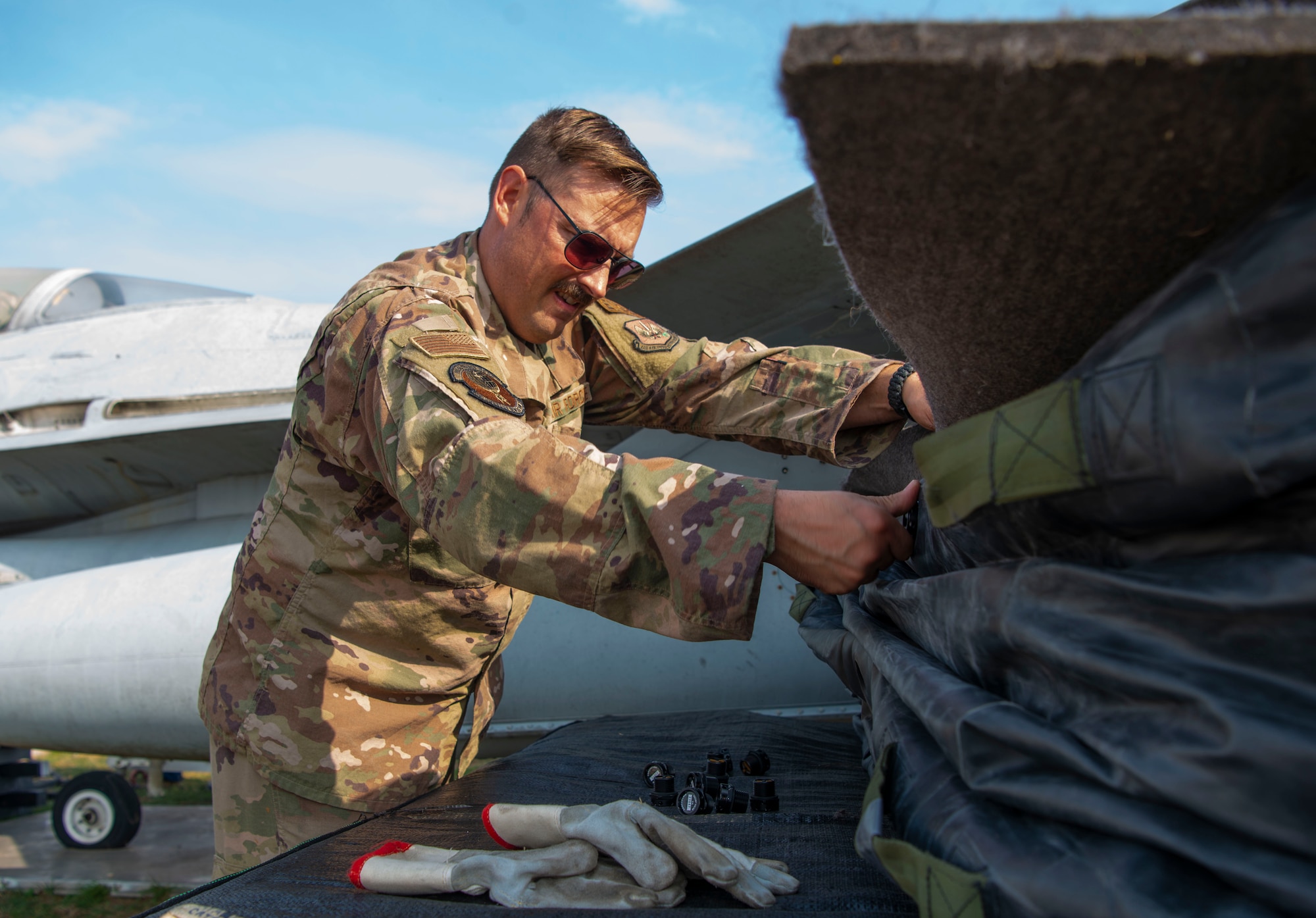 Tech. Sgt. Thomas Niewulis, 56th Rescue Generation Squadron support section NCOIC, pack up a lift bag during a crashed, damaged or disabled aircraft (CDDAR) recovery training at Aviano Air Base, Italy, Oct. 20, 2022. These trainings give Airmen practice needed to execute real-world recoveries effectively. (U.S. Air Force photo by Airman 1st Class Thomas Calopedis)