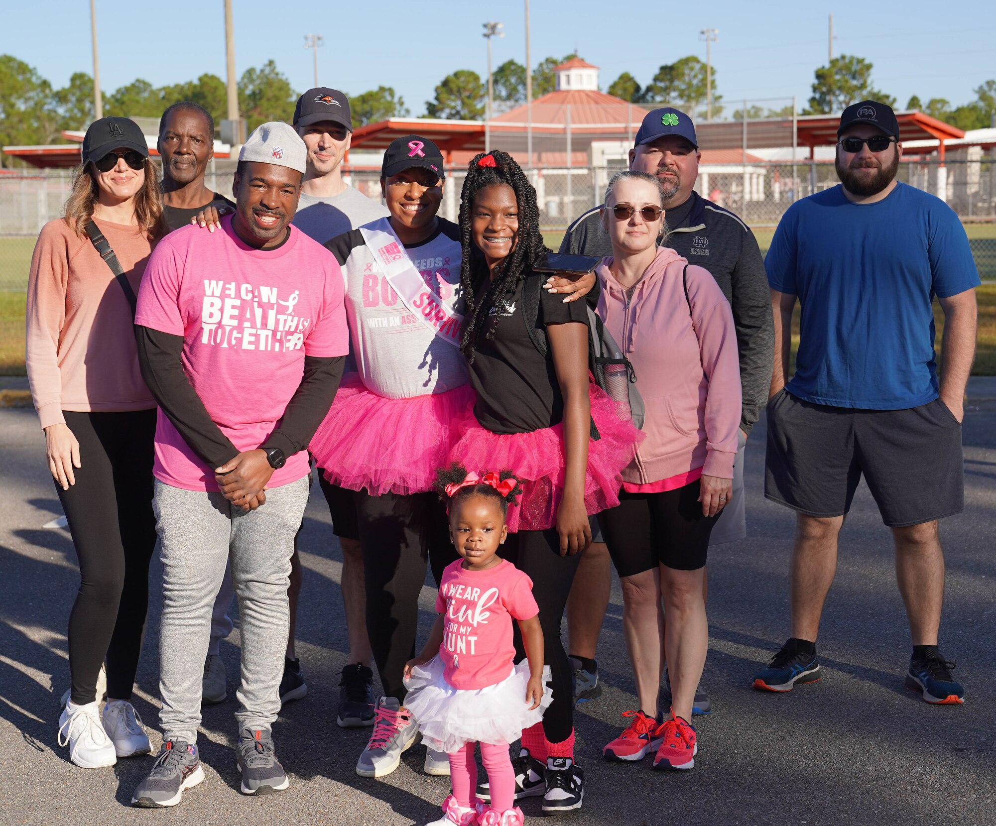 U.S. Air Force Tech. Sgt. LeVonya Davis, 81st Medical Support Squadron medical information systems section chief, poses with family and friends at the Mississippi Gulf Coast Strides Against Breast Cancer 5K in held at the AJ Holloway Sports Complex in Biloxi, Mississippi, Oct. 15, 2022.