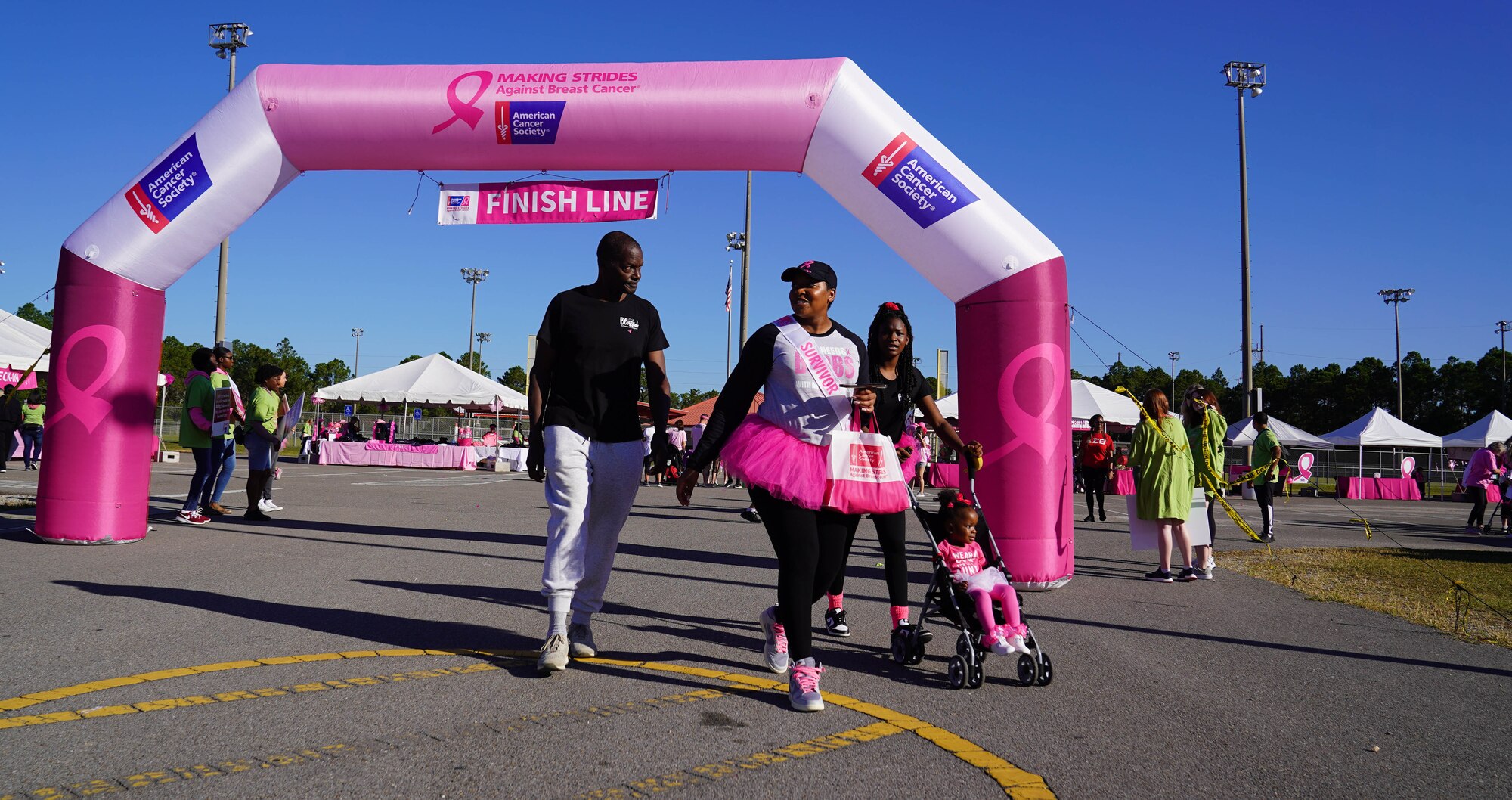 U.S. Air Force Tech. Sgt. LeVonya Davis, 81st Medical Support Squadron medical information systems section chief, walks with family members at the Mississippi Gulf Coast Strides Against Breast Cancer 5K in held at the AJ Holloway Sports Complex in Biloxi, Mississippi, Oct. 15, 2022.