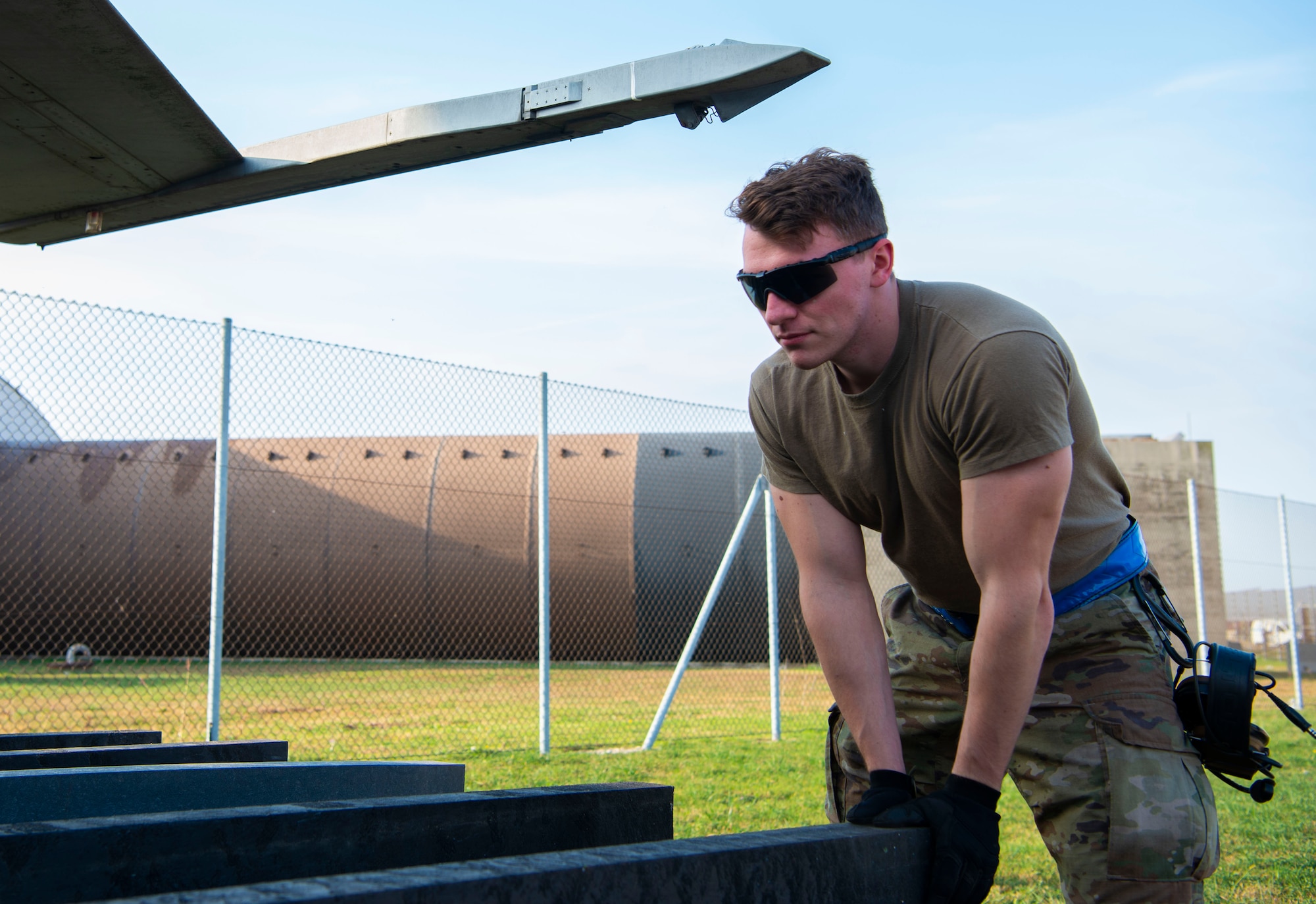 Senior Airman Nate Marker, 86th Maintenance Squadron crashed, damaged or disabled aircraft recovery (CDDAR) crew chief, sets up dunnage for a bag lift during CDDAR training at Aviano Air Base, Italy, Oct. 20, 2022. The joint training included Airmen from Ramstein Air Force Base, Germany, as well as others. (U.S. Air Force photo by Airman 1st Class Thomas Calopedis)