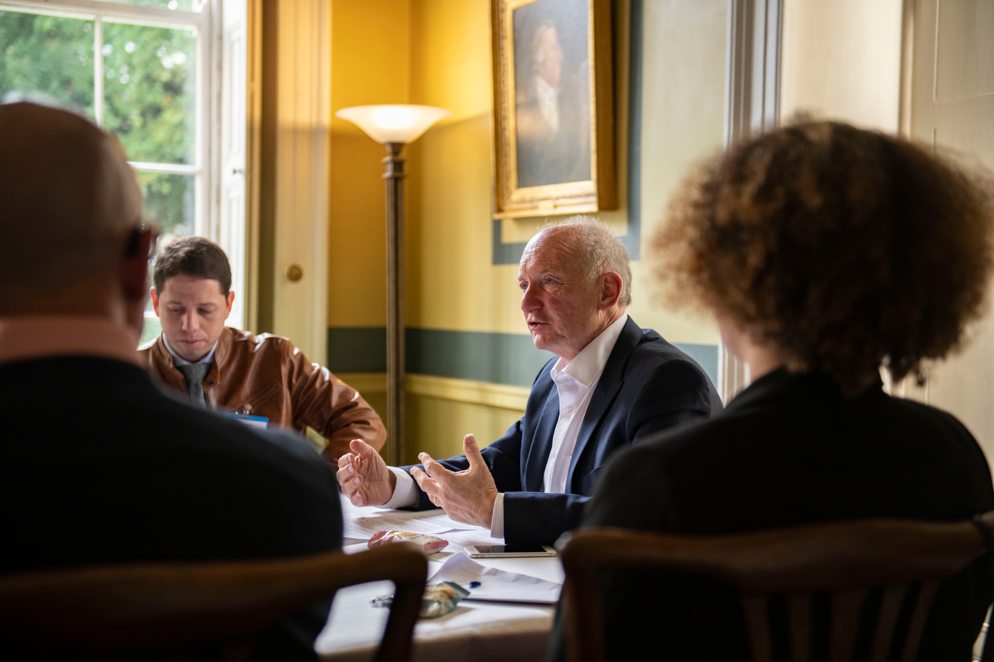 Alan Bookbinder, Downing College master, center, talks with members of the Leadership Connect program