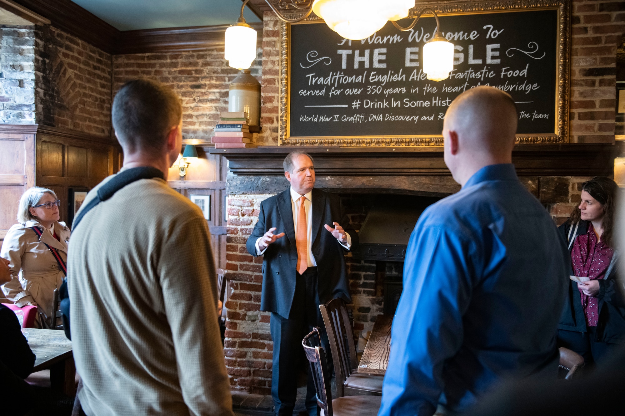 Christopher Walkinshaw, British-American Committee chairman, teaches members of the Leadership Connect program about the history of the Royal Air Force pub, in Cambridge