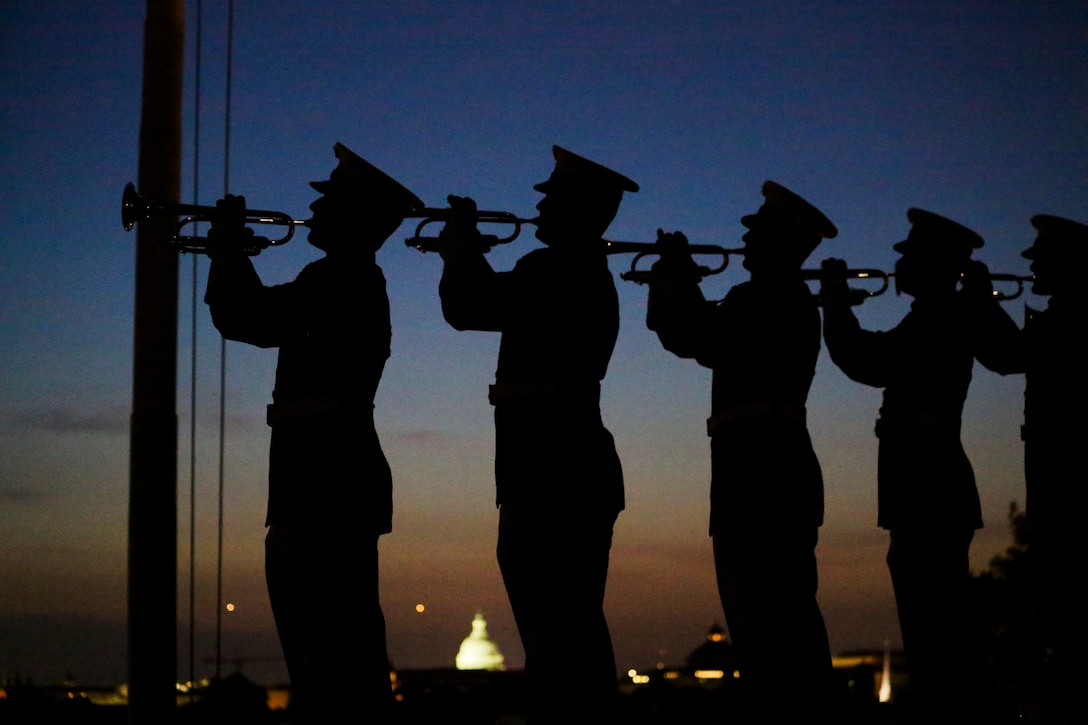 U.S. Marines with 'The Commandant’s Own' U.S. Marine Corps Drum & Bugle Corps play Taps during a Friday Evening Parade at Marine Barracks Washington D.C., May 25, 2018. The guests of honor for the parade were Gold Star Families and the hosting official was Lt. Gen. Robert S. Walsh, commanding general, Marine Corps Combat Development Command, and deputy commandant, Combat Development and Integration.