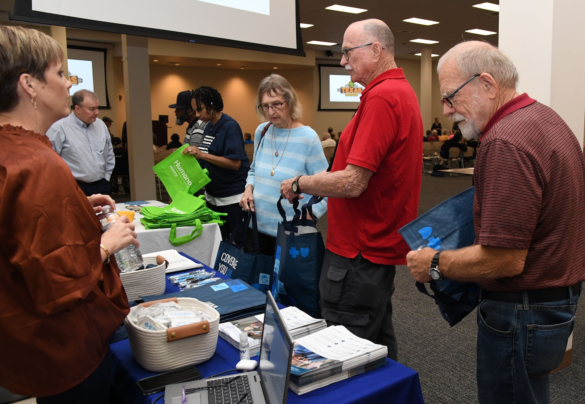 Tara Cote, Blue Cross Blue Shield senior group representative, provides information to retirees during Retiree Appreciation Day inside the Roberts Consolidated Aircraft Maintenance Facility at Keesler Air Force Base, Mississippi, Oct. 28, 2022.