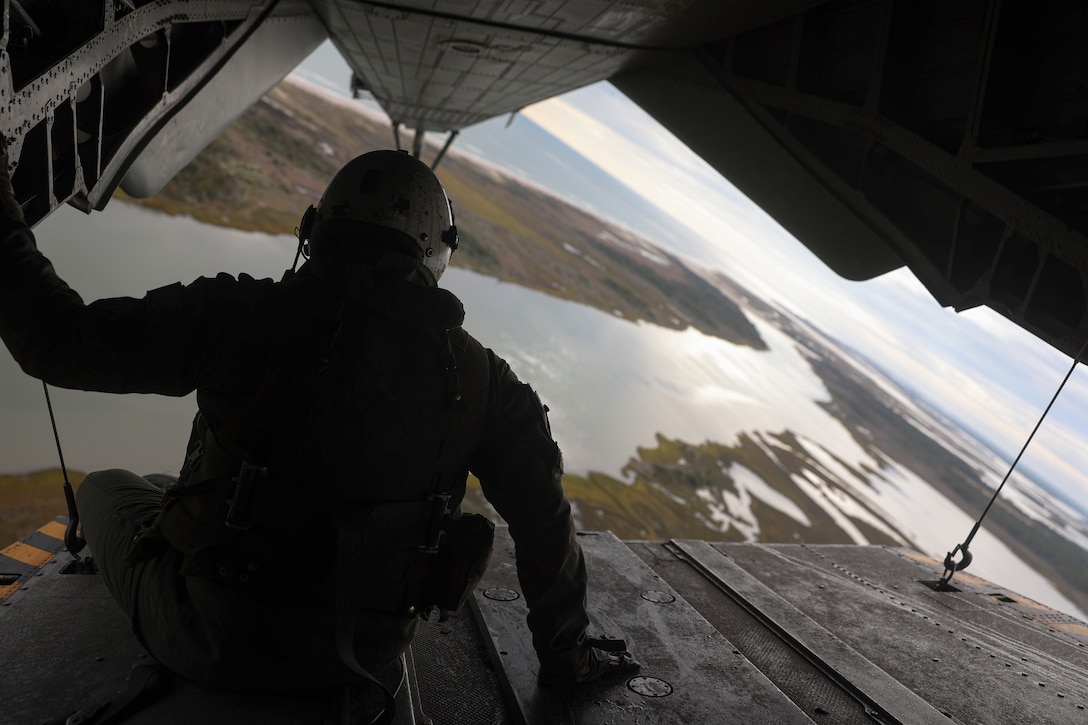 A U.S. Marine with Marine Heavy Helicopter Squadron 366, 2nd Marine Aircraft Wing, looks out the rear of a CH-53E Super Stallion during helocast water insertion training on Marine Corps Base Camp Lejeune, North Carolina, Oct. 26, 2022. Helocasting is an airborne technique used by small unit special operations forces to insert into hard-to-reach areas via bodies of water. This high-risk training prepares the Maritime Special Purpose Force for the upcoming 26th Marine Expeditionary Unit deployment.