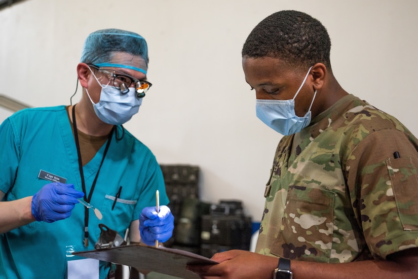 Senior Airman Tabari Matthews, 189th dental technician, assists Canadian Army Capt. Cleve Kim, dentist, in Puerto Barrios, Guatemala, Oct. 28, 2022, during Continuing Promise 2022. Arkansas Air National Guard members worked alongside U.S. and foreign military forces, government officials and civilian personnel to provide medical care, improve interoperability, and develop enduring relationships.