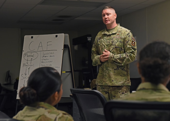 U.S. Air Force Master Sgt. Andrew Mundy, 316th Training Squadron instructor, talks with students about comprehensive Airmen fitness, Goodfellow Air Force Base, Texas, Oct. 27, 2022. CAF’s mission is to build and sustain a resilient Air Force community by fostering mental, social, spiritual, and physical fitness. (U.S. Air Force photo by Airman 1st Class Zachary Heimbuch)