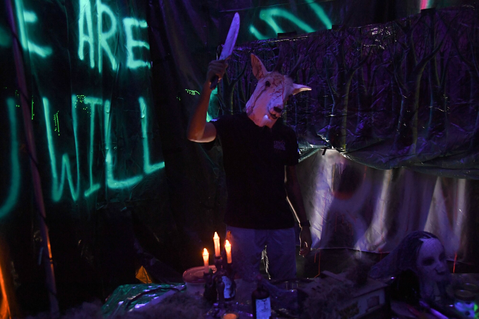 U.S. Air Force Airman 1st Class Kaleb Beasley, 81st Force Support Squadron student assignment technician, volunteers inside the haunted house during Ghouls in the Park at the marina park at Keesler Air Force Base, Mississippi, Oct. 28, 2022.