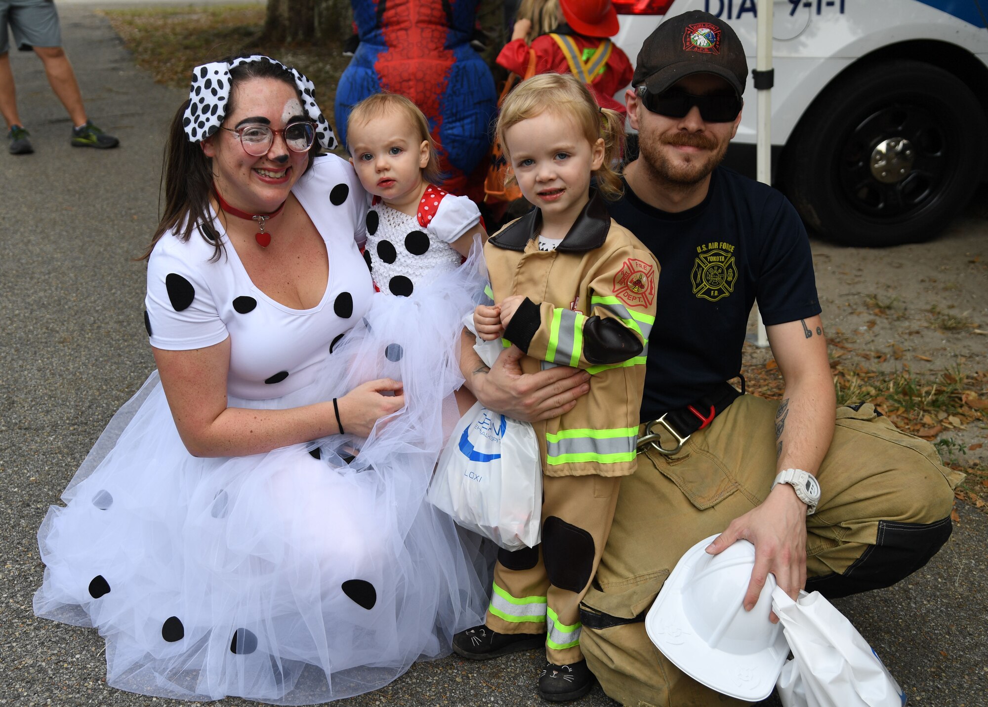 The family of U.S. Air Force Staff Sgt. Zachary Schofield, 81st Civil Engineer Squadron crew chief, and his family pose for a photo during Ghouls in the Park at the marina park at Keesler Air Force Base, Mississippi, Oct. 28, 2022.