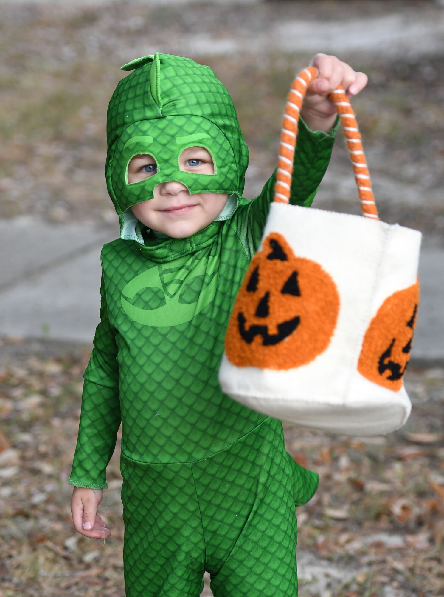 Christian Groue, grandson of Kemberly Groue, 81st Training Wing public affairs photojournalist, shows off his basket full of candy during Ghouls in the Park at the marina park at Keesler Air Force Base, Mississippi, Oct. 28, 2022.
