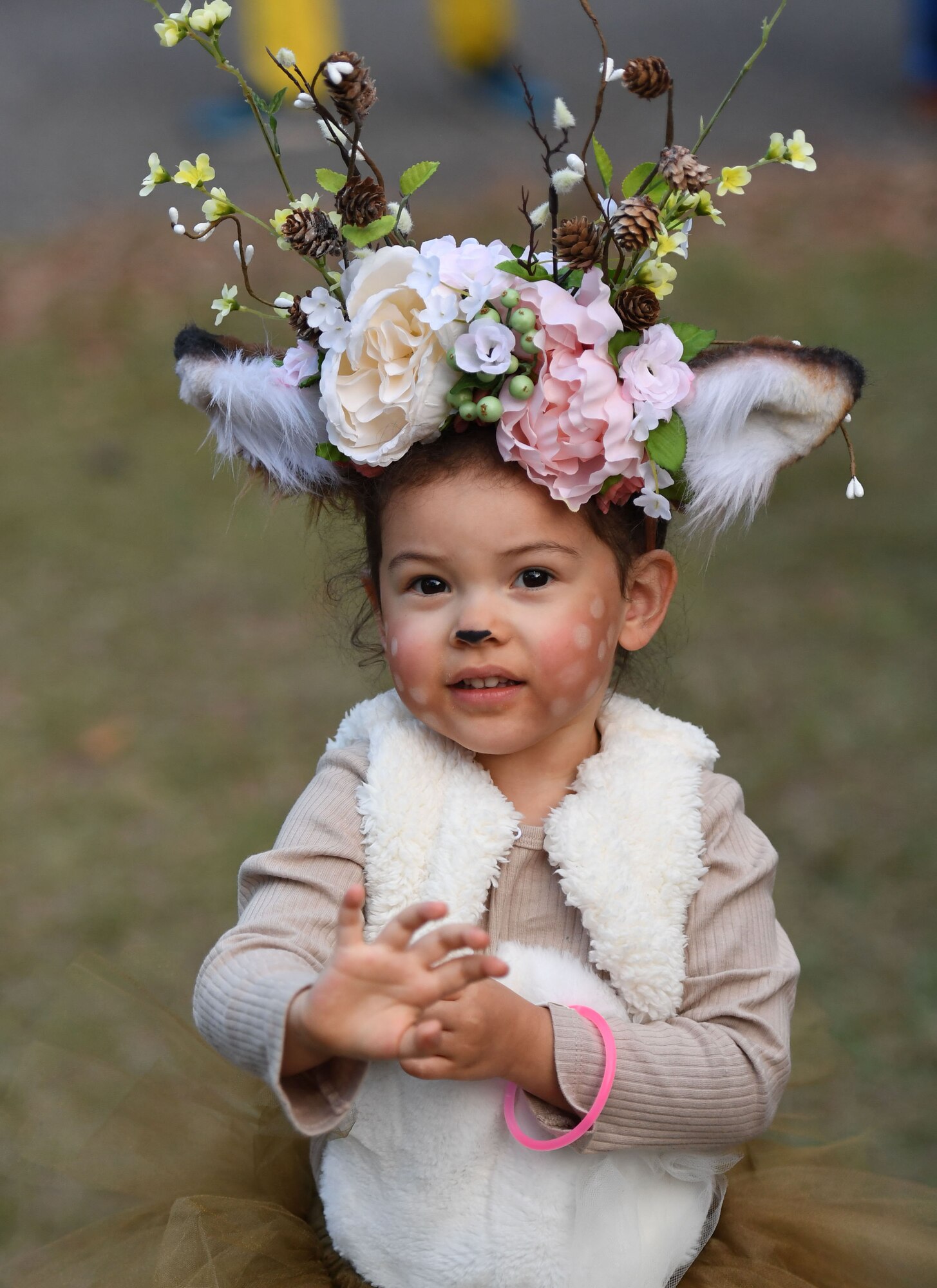 Lillian Tucker, daughter of U.S. Navy Aerographer's Mate 1st Class David Tucker, Stennis Space Center petty officer 1st Class, shows off her costume during Ghouls in the Park at the marina park at Keesler Air Force Base, Mississippi, Oct. 28, 2022.