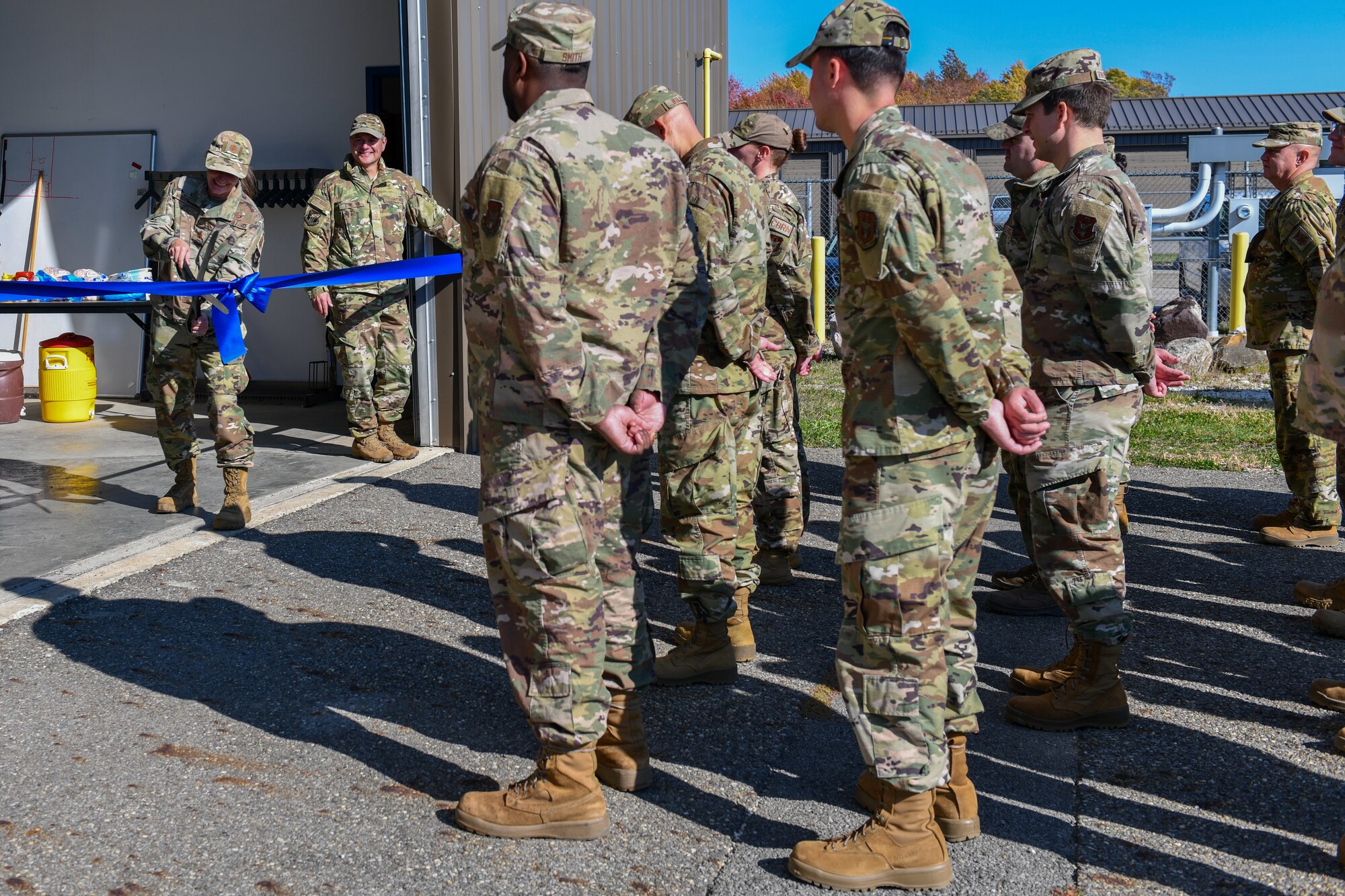 Maj. Tiffany Van Den Broeke, 910th Civil Engineer Squadron commander, cuts the ribbon for a recently completed squadron training building here, Oct. 15, 2022.