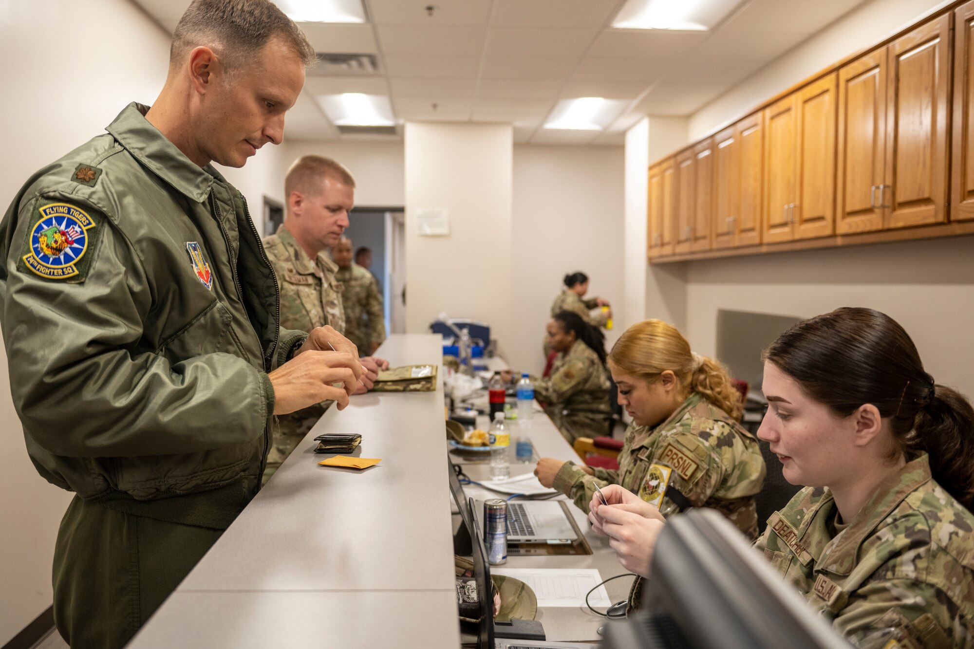 Airmen assigned to the 23rd Wing process through a personnel deployment function line.