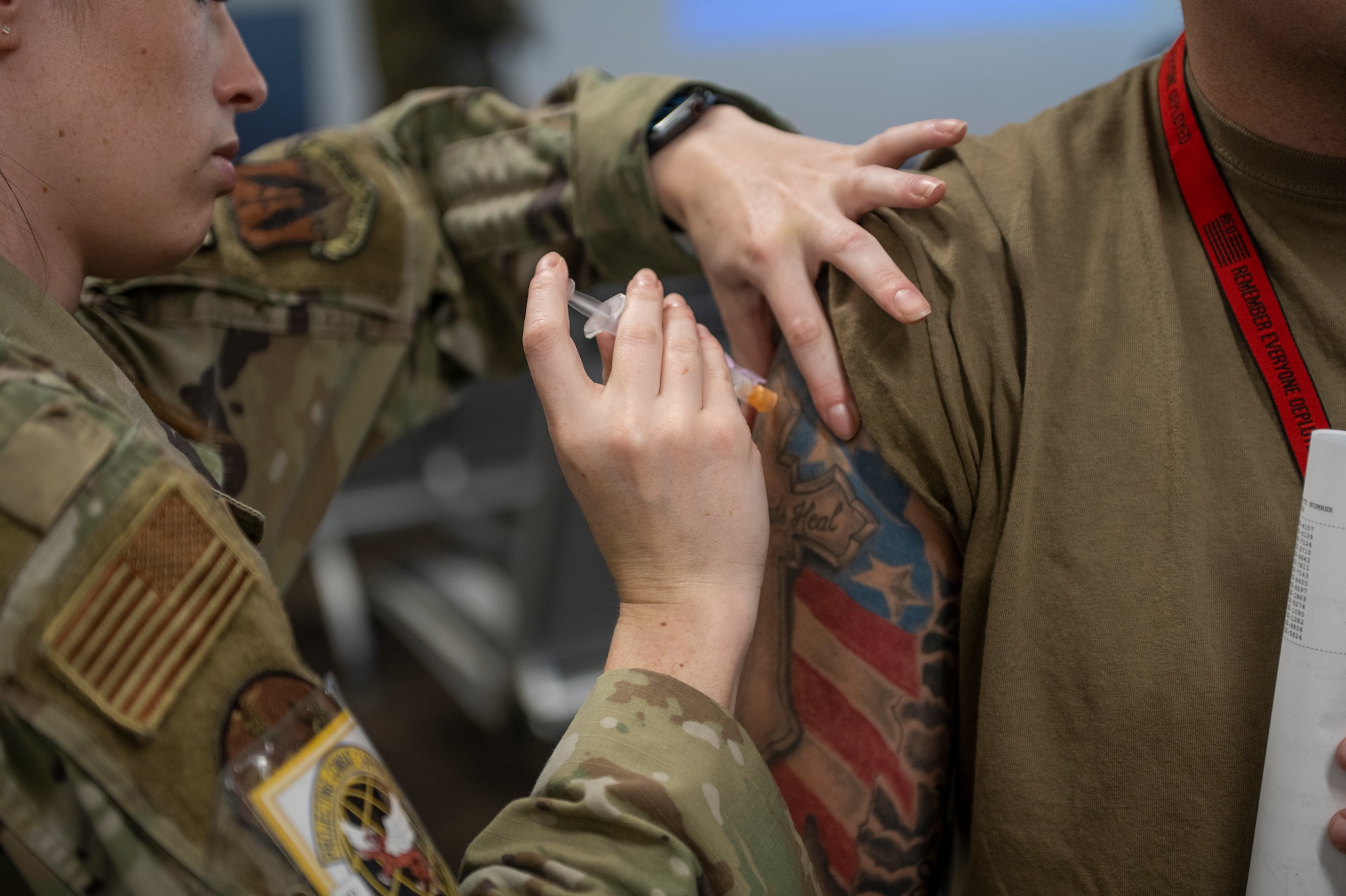 Airmen administers a typhoid immunization