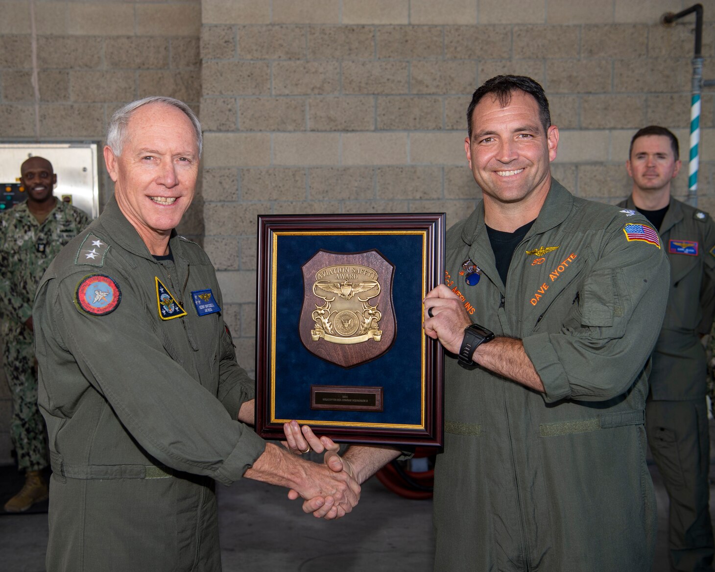 Vice Adm. Kenneth Whitesell, Commander, U.S. Naval Air Forces, left, presents the 2021 Chief of Naval Operations (CNO) Aviation Safety Award to Capt. David Ayotte, commanding officer of the “Merlins” of Helicopter Sea Combat Squadron (HSC) 3, during an award ceremony held aboard Naval Air Station North Island, Oct. 20, 2022