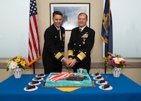 NAVAL BASE KITSAP – BANGOR, Wash. (Oct. 19, 2022) Capt. Gary Montalvo, commodore, Submarine Development Group 5, left, and Adm. Stuart Munsch, commander, U.S. Naval Forces Europe-Africa, cut a cake during a ceremony for a newly-completed service pier located on Naval Base Kitsap – Bangor, October 19, 2022. The ceremony marked the completion of a major infrastructure project that will support the arrival of fast attack submarines, including the planned change of homeport for the Seawolf-class fast-attack submarines USS Seawolf (SSN 21) and USS Connecticut (SSN 22) from Naval Station Kitsap-Bremerton to Naval Base Kitsap-Bangor. (U.S. Navy photo by Mass Communication Specialist 1st Class Brian G. Reynolds)