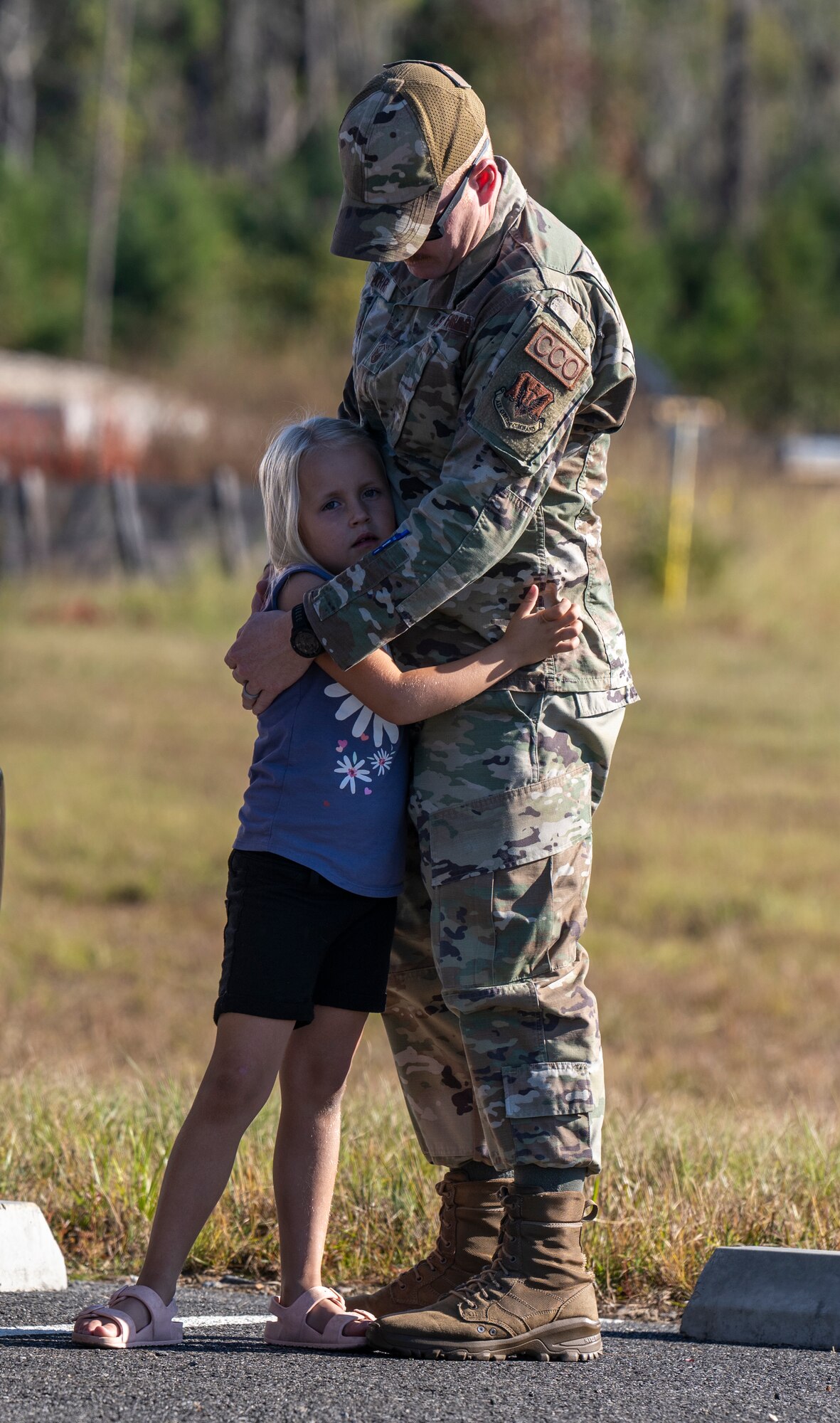 An Airman hugs his daughter before deploying.