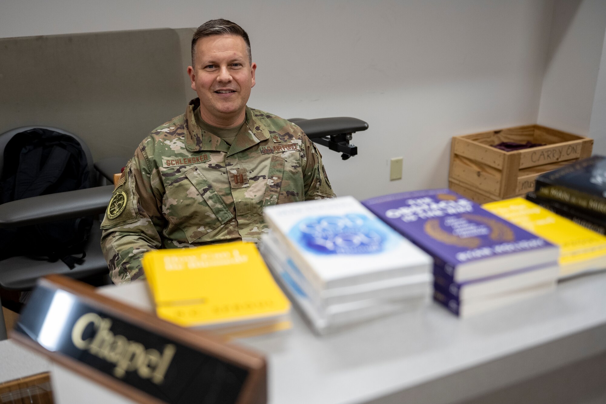 A chaplain provides resources to Airmen deploying.