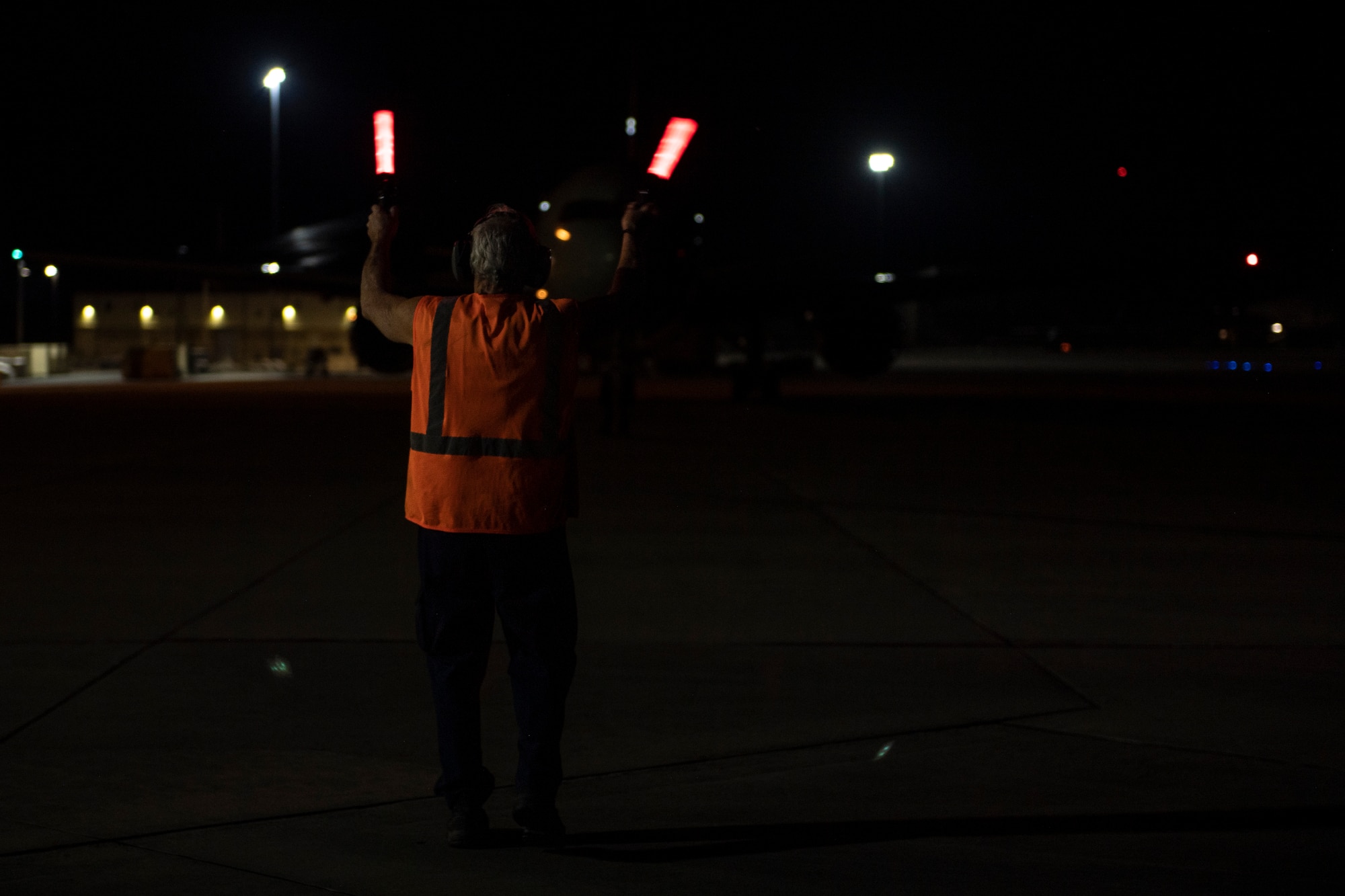 U.S. Air Force Paul Dunning, 23rd Maintenance Group aircraft servicer, marshals an aircraft