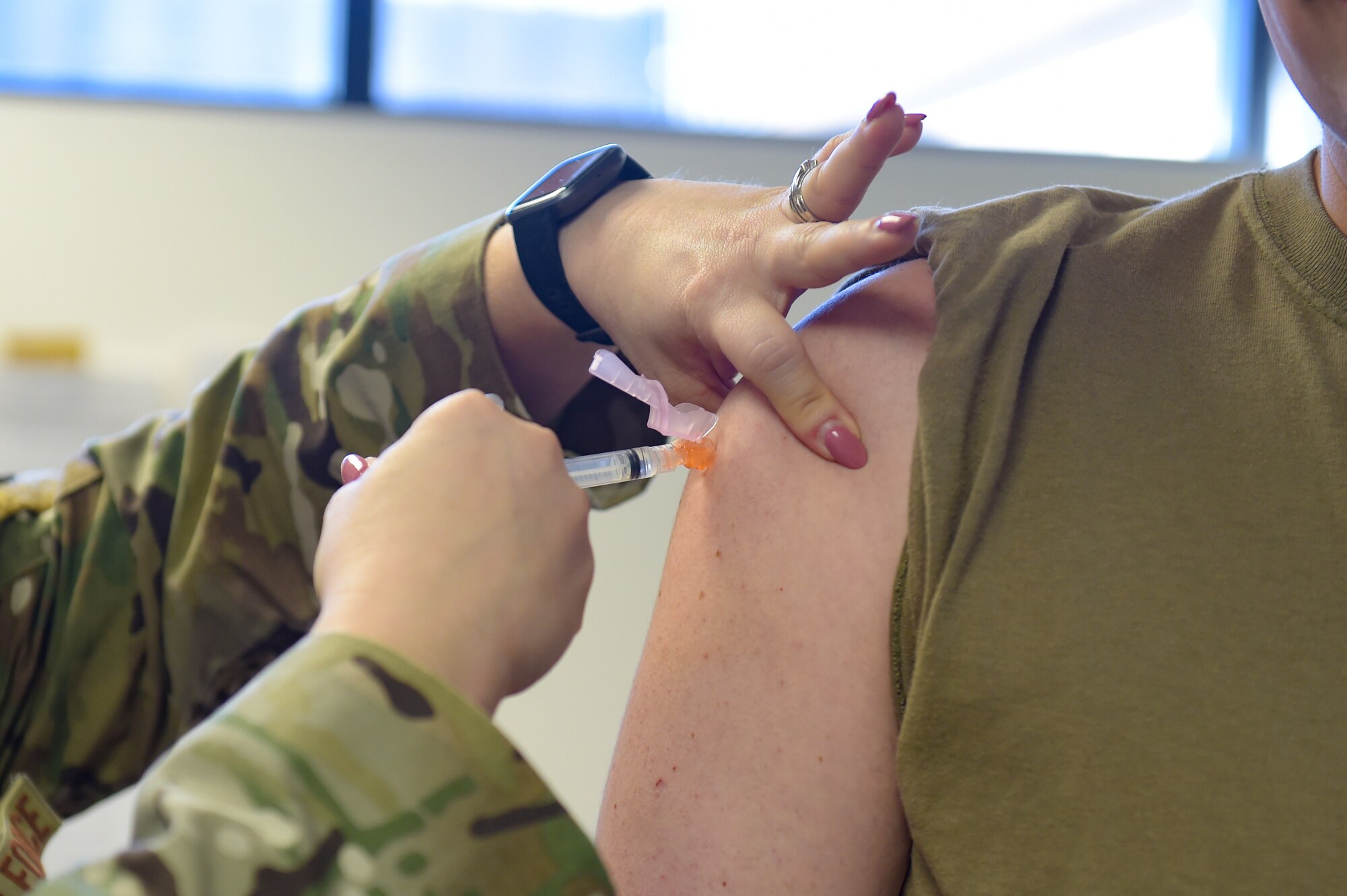 A photo of Airmen receiving vaccine.