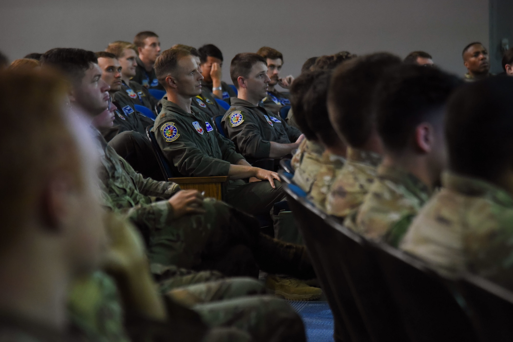 A photo of Airmen sitting.