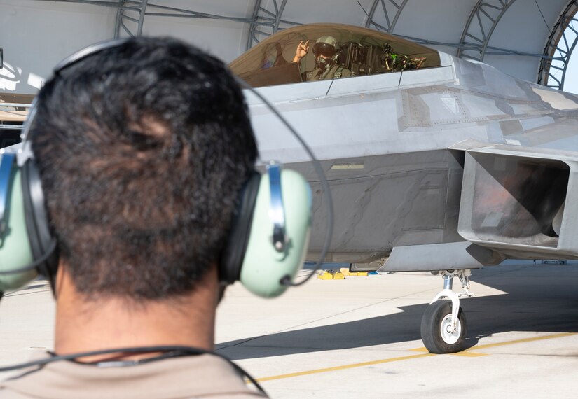 JOINT BASE LANGLEY-EUSTIS, VA—A pilot from the 94th Fighter Squadron, signals his crew chief prior to taxiing to the runway during the Battle of Britain Commemoration held by the 1st Fighter Wing, Joint Base Langley-Eustis, Virginia, Oct. 21, 2022. The event consisted of a replication of the battle in the air, a historical briefing and a comparison at the end of the day to see how the pilots did in relation to the actual Battle of Britain. (U.S. Air Force photo by Tech. Sgt. Matthew Coleman-Foster)