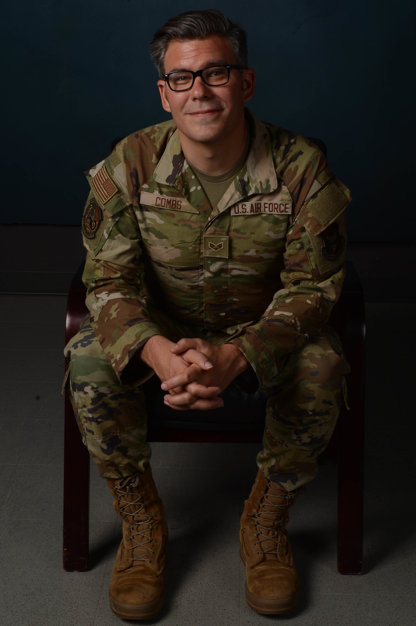 A person in a military uniform sitting in a chair.