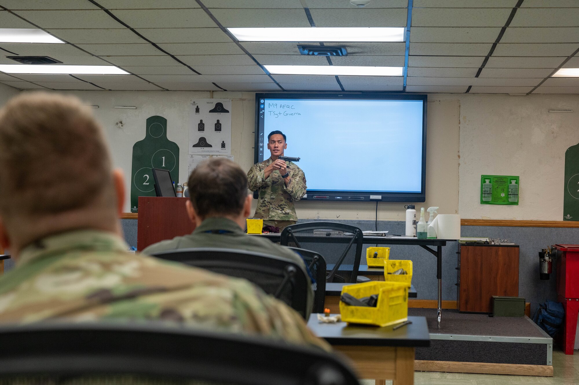 U.S. Air Force Tech. Sgt. Joseluis Guerra, 56th Security Forces Squadron Combat Arms instructor, demonstrates proper technique with an M9 service pistol during a qualification course, Oct. 27, 2022, at Luke Air Force Base, Arizona.