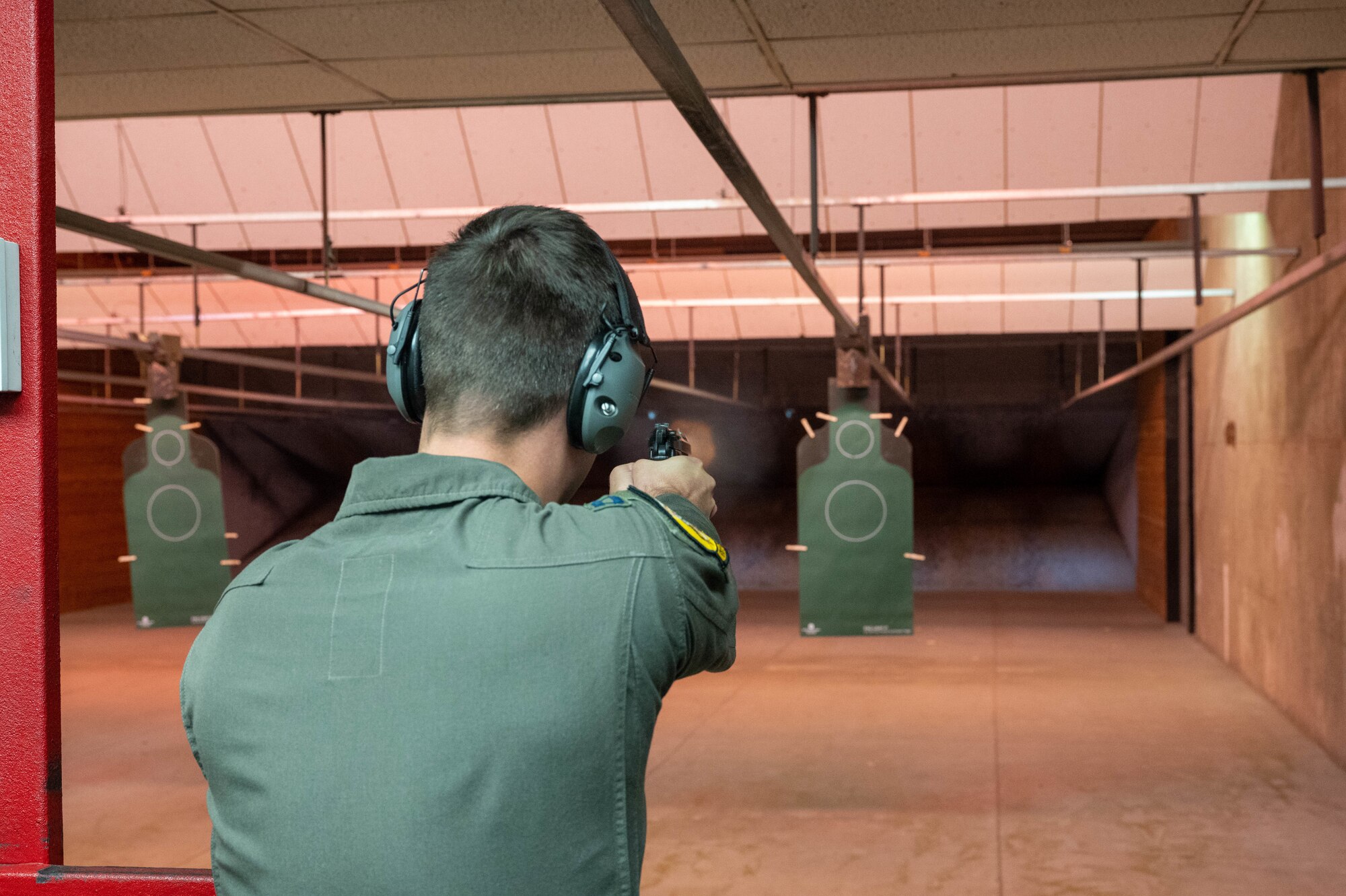 U.S. Air Force Capt. Joshua Schoettelkotte, 61st Fighter Squadron student pilot, fires at a target with an M9 service pistol during a qualification course, Oct. 27, 2022, at Luke Air Force Base, Arizona.